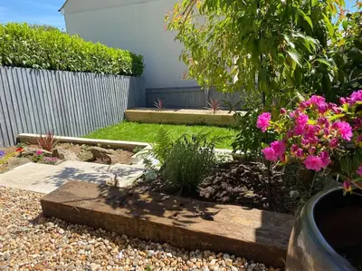 a garden with pink flowers and a fence at Stylish 3 bed home with allocated parking for 2 in Liskeard
