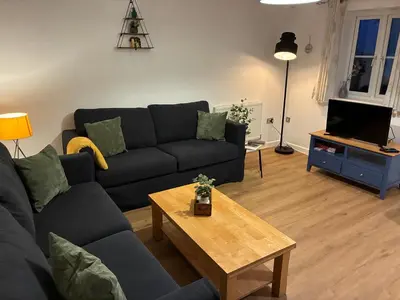 a living room with a couch and a coffee table at Stylish 3 bed home with allocated parking for 2 in Liskeard