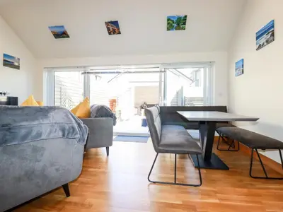 a living room with a table and a couch at Clonmore in Bodmin