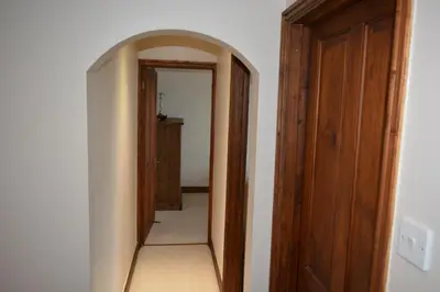 a hallway with an archway leading into a room at White Hart Cottage, Menheniot, Nr Looe in Menheniot