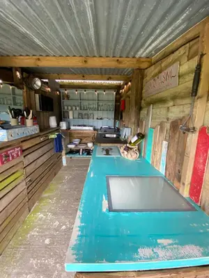 a kitchen with a blue counter in a room at Stunning views & sunrises from Sally Saracen in St Ives