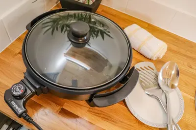 a frying pan on a table with a spatula at Rose in Redruth
