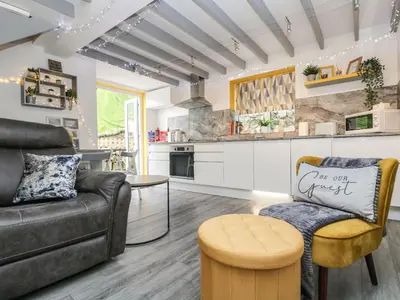 a living room with a couch and a kitchen at The Hideaway in Chacewater