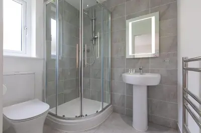 a bathroom with a shower and a toilet and a sink at Hebaska in Carbis Bay