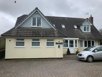 a house with a car parked in front of it at Little Valley View in Otterham