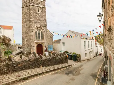 a street in front of a church with flags at Foxes Den in Saint Goran