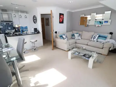 a living room with a couch and a table at Ocean Blue in Carbis Bay