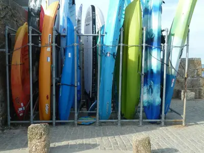 a bunch of surfboards lined up in a rack at Grey Mullet Guesthouse in St Ives