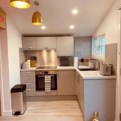 a kitchen with a sink and a stove top oven at SHINE CHALET - UNIQUE & COMFORTABLE ACCOMMODATION in Redruth