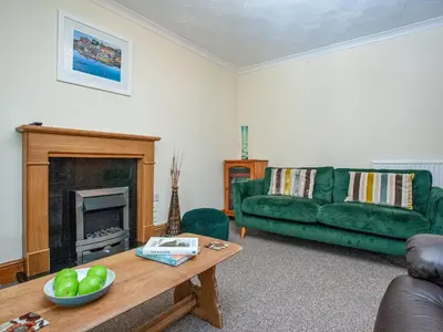 a living room with a green couch and a table at Tanglewood in Bugle