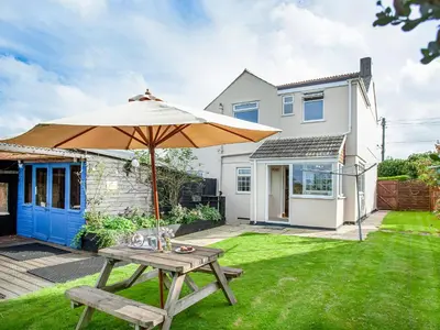 a picnic table with an umbrella in the yard of a house at Tanglewood in Bugle