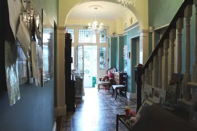 a hallway of a home with a staircase and a living room at Penrose Bed & Breakfast in Lostwithiel