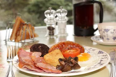 a plate of breakfast food on a table at Penrose Bed & Breakfast in Lostwithiel