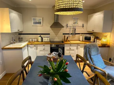 a kitchen with a table with a plant on it at Cargibbitt Annexe in Liskeard