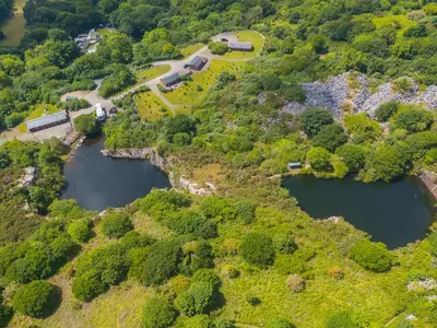 an aerial view of two reservoirs on a hill at Branock, Tor Down Quarry in Bodmin