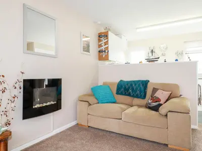 a living room with a couch and a fireplace at Smugglers in Liskeard