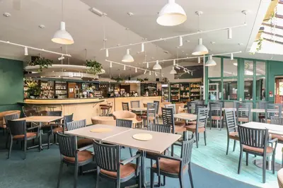 a restaurant with tables and chairs and a bar at Morton Cottage in Falmouth