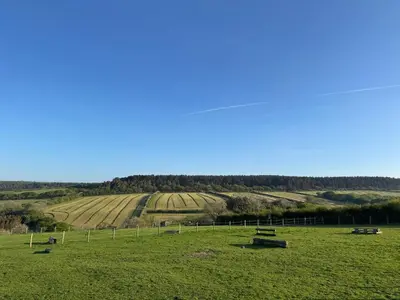 a field with benches in the middle of a field at The Old Stable - Flat 1 in Wadebridge