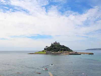 an island with a castle on it in the water at Larch Barn in Helston