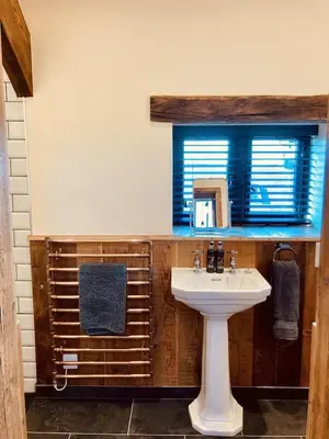 a bathroom with a sink and a window at The Stable at Widemouth Bay - 2 bedroom cottage in Poundstock