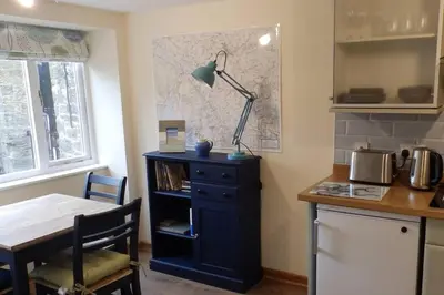 a kitchen with a table and a lamp on a cabinet at 1 bed-Pet Friendly-Parking-Patio-close to coasts in North Hill