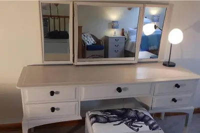 a white dresser with a mirror and a dressing table at 1 bed-Pet Friendly-Parking-Patio-close to coasts in North Hill
