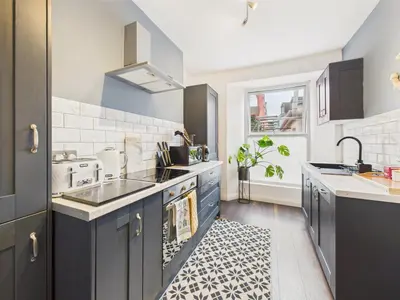 a kitchen with a sink and a stove top oven at Central Falmouth Flat with Free Parking in Falmouth
