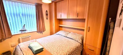 a small bedroom with a bed and a window at 9 Wheal Ramoth in Perranporth
