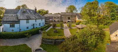 an aerial view of a house with a yard at Linhay at East Trenean Farm -Luxury retreat for 2 with stunning rural views, private hot tub and EV charging in Looe