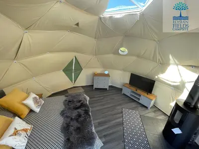 a teddy bear is sitting in a tent at Glamping Dome Elysian Fields in Helston