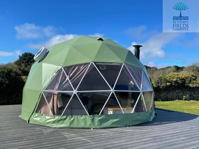a green tent sitting on top of a deck at Glamping Dome Elysian Fields in Helston