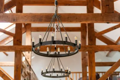 two chandeliers hanging from a wooden ceiling at Threshing Barn at East Trenean Farm -Stunning Cornish Cottage sleeping 6 with hot tub, private garden, rural views and EV facilities in East Looe