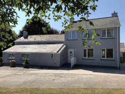 a white house with a driveway in front of it at The Cottage, Cox Hill House, Cox Hill, Chacewater, TR4 8LY in Truro