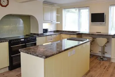 a kitchen with a counter top and a stove at Large Family House - sleeps 10. Central Location. 15 mins from coast. in Truro