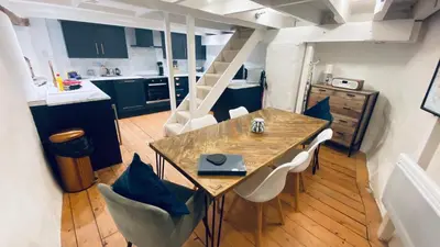 a kitchen and dining room with a table and chairs at SPINDRIFT is A Beautiful Newly Refurbished THREE BEDROOM Private Family House located on the OLD HARBOUR and the COASTAL PATH in the Heart of Beautiful POLPERRO in Polperro
