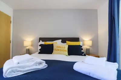a bedroom with a bed with white towels on it at Trewhiddle 41 by Together Travel - Stylish Coastal Countryside Retreat in St Austell