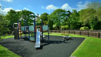 a playground with a slide in a park at 15 Tudor Court, Tolroy Manor in Hayle