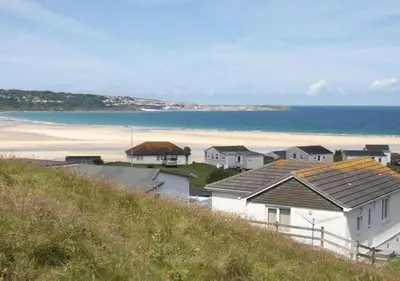 a view of a beach with houses and the ocean at D38 Miramar, Riviere Towans in Hayle