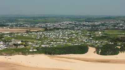 an aerial view of a town on the beach at E30 Lant View, Riviere Towans in Hayle