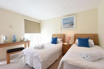 a bedroom with two beds with towels on them at Ocean View in Carbis Bay