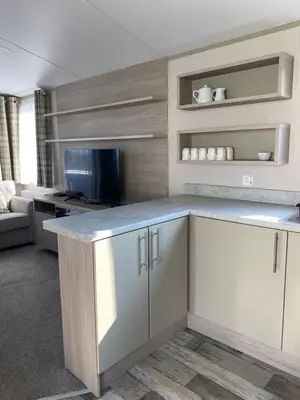 a kitchen with white cabinets and a counter top at Luxury Holiday Home Sleeps 6 Pet Friendly in St Austell