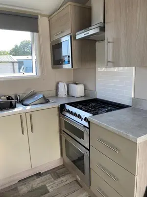 a kitchen with a stove and a counter top at Luxury Holiday Home Sleeps 6 Pet Friendly in St Austell