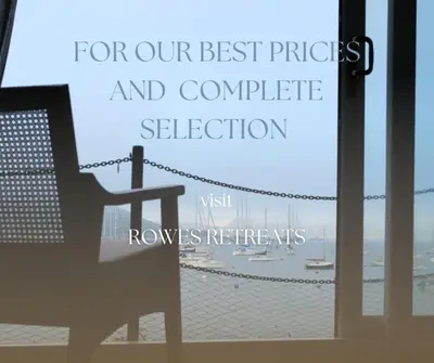 a bench in front of a window with a view of the ocean at Breathtaking High Street Townhouse With Stunning Sea Views at 'The Old Fishermans Townhouse' in Falmouth