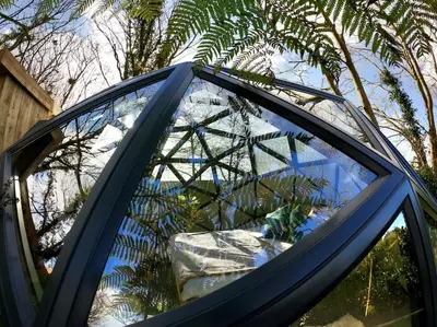 a glass roof of a car parked in a yard at Romance - Stargazing - Hot tub & sauna! in Camborne