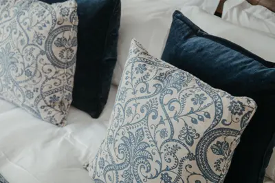 two pillows are sitting on a bed next to sidx at Marners Rock No 1 in Fowey