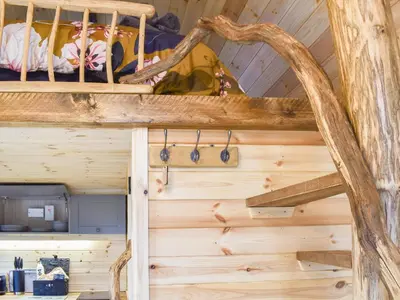 a room in a log cabin with wooden walls at Krowji Klys in Boscastle