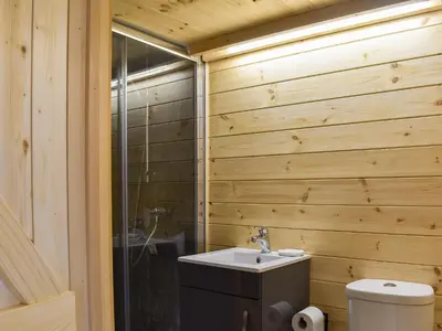 a wooden bathroom with a sink and a toilet at Krowji Klys in Boscastle