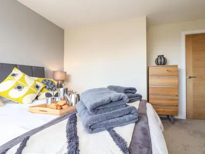 a bedroom with a bed with towels on it at Pickney House in Looe