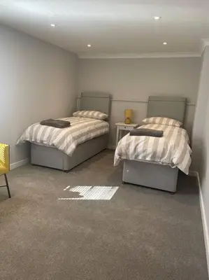 a room with two beds in a room at Sunny Corner - lovely 2 bedroom appt in Redruth