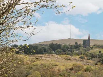 a view of a hill with a tower in the distance at Mole Cottage in Liskeard